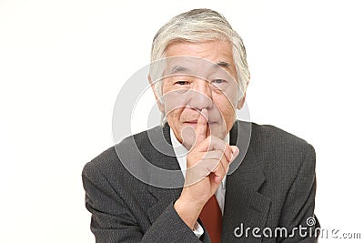 Senior Japanese businessman whith silence gestures Stock Photo