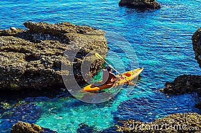 Senior kayaker on a kayak by the sea, active water sport and lei Editorial Stock Photo