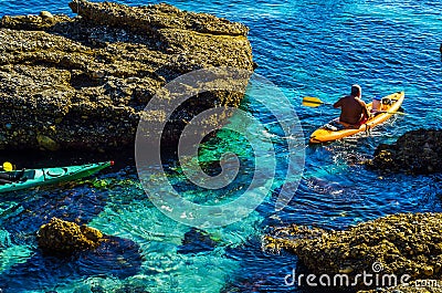 Senior kayaker on a kayak by the sea, active water sport and lei Editorial Stock Photo