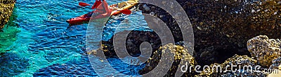 Senior kayaker on a kayak by the sea, active water sport and lei Stock Photo