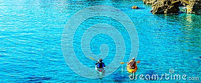 Senior kayaker on a kayak by the sea, active water sport and lei Stock Photo