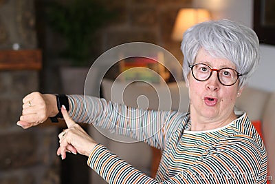 Senior lady complaining about punctuality Stock Photo
