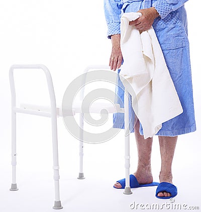 Senior lady beside shower seat Stock Photo