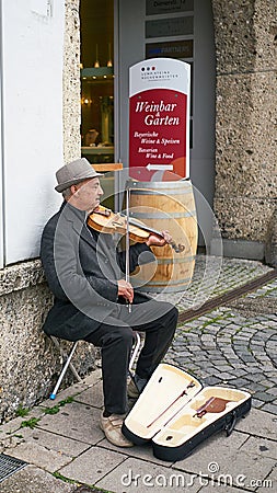 Senior Male Violinist plays music on a street in Munich, Germany Editorial Stock Photo