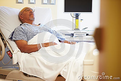 Senior Male Patient Resting In Hospital Bed Stock Photo