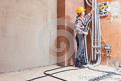 Senior male technician measuring the pipe with ruler Stock Photo