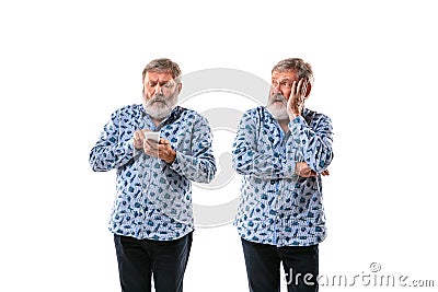 Senior man arguing with himself on white studio background. Stock Photo