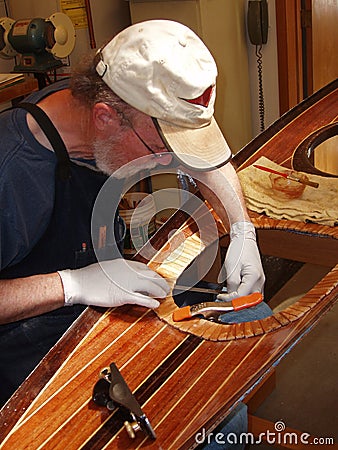 Senior man building wood strip kayak Stock Photo