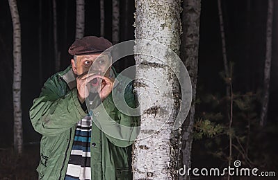Senior man calling for help lost in a forest Stock Photo