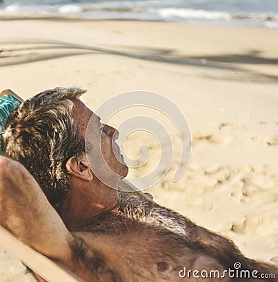 Senior man chilling on the beach Stock Photo