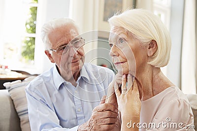 Senior Man Comforting Woman With Depression At Home Stock Photo