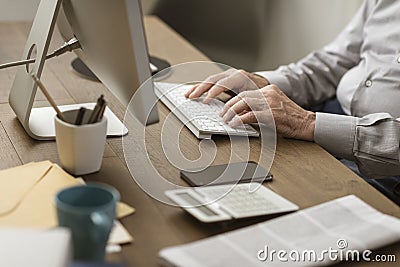 Senior man connecting with his computer at home Stock Photo