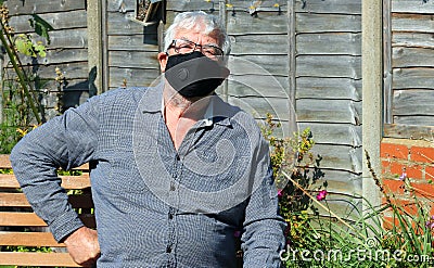 Senior man with covid mask looking happy and relaxed. Stock Photo