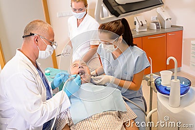 Senior man at dentist surgery have treatment Stock Photo