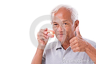 Senior man with denture, giving thumb up Stock Photo