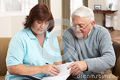 Senior Man In Discussion With Health Visitor Stock Photo