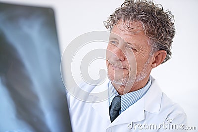 Senior man, doctor and xray for healthcare, injury analysis and anatomy with radiology and happiness. Mature, face and Stock Photo