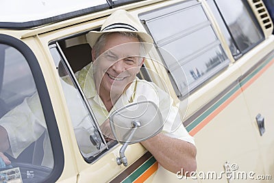 Senior Man In Driver's Seat Of Campervan Looking Through Window Stock Photo