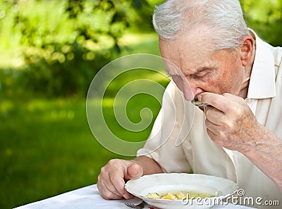 Senior man eating Stock Photo