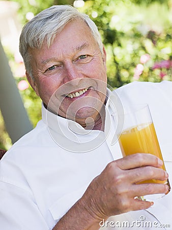 Senior man enjoying glass of juice Stock Photo