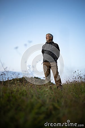 Senior man enjoying the outdoors walking throught lovely nature Stock Photo