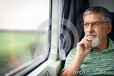 Senior man enjoying a train travel Stock Photo