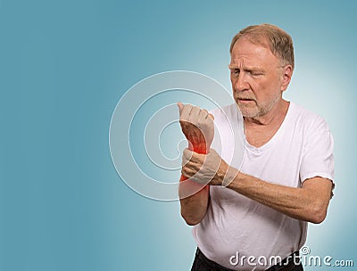 Senior man in excruciating hand ache painful wrist arthritis Stock Photo
