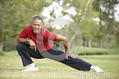 Senior Man Exercising In Park Stock Photo