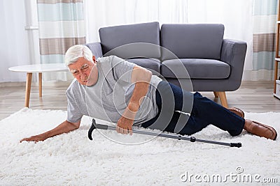 Senior Man Fallen On Carpet Stock Photo