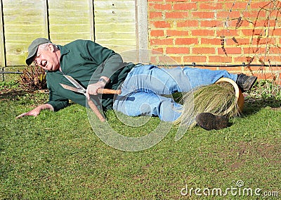 Senior man fallen over. Garden accident. Stock Photo