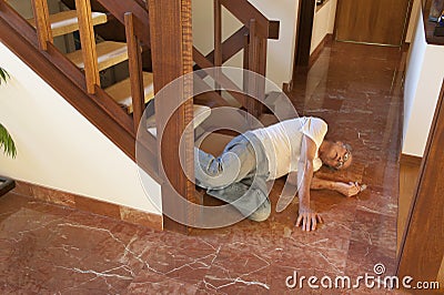 Senior man fell down the stairs Stock Photo