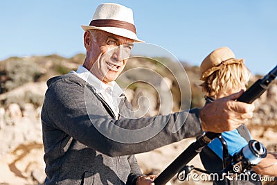 Senior man fishing with his grandson Stock Photo