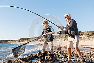 Senior man fishing with his grandson Stock Photo