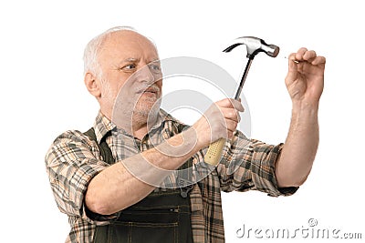 Senior man hammering Stock Photo