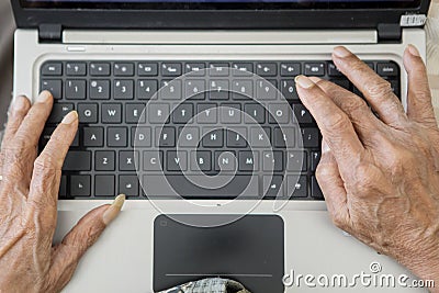 Senior man hands typing on the laptop computer Stock Photo