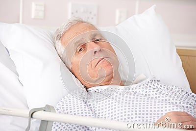 Senior man ill in hospital bed Stock Photo