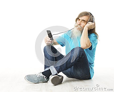 Senior man listening music in phone headphones. Old man beard Stock Photo