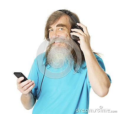 Senior man listening music in phone headphones. Old man beard Stock Photo