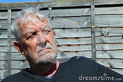 Senior man looking defiant at camera. Stock Photo