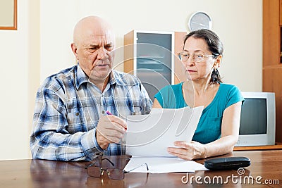 Senior man with mature woman fills in questionnaire Stock Photo