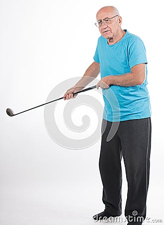 Senior man on white background plays golf Stock Photo