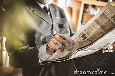 Senior man reading newspaper. Stock Photo