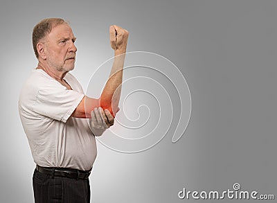 Senior man with red elbow inflammation suffering from pain Stock Photo