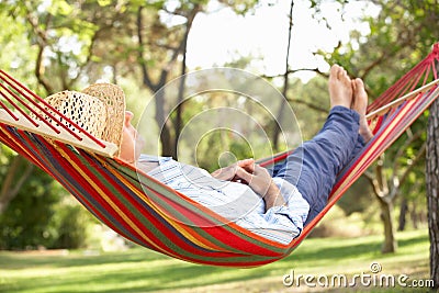 Senior Man Relaxing In Hammock Stock Photo