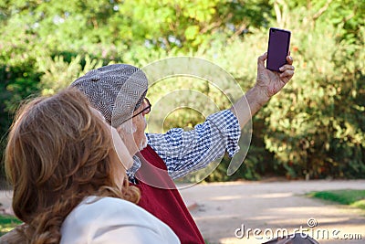 Senior man and senior woman doing a self-portrati Stock Photo