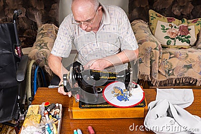 Senior Man Sewing Needle Point Craft with Machine Stock Photo