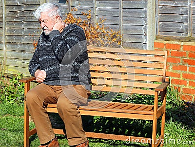 Arthritis. Senior man holding neck in pain Stock Photo