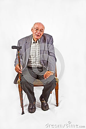 Senior man sitting in his armchair Stock Photo