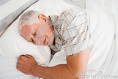 Senior man sleeping on bed Stock Photo
