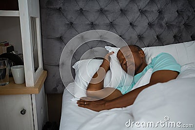 Senior man sleeping on bed at home Stock Photo